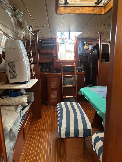 Challenger Yacht Photos Pics Interior of a 1992 Hallberg-Rassy 45 sailboat, featuring wooden finishes and nautical decor.