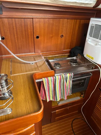 Challenger Yacht Photos Pics Galley of 1992 Hallberg-Rassy 45 yacht with stove and wooden cabinetry.