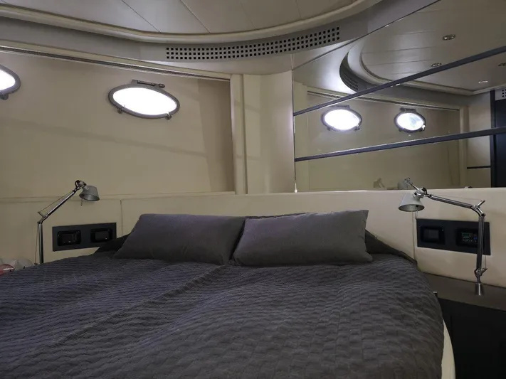  Yacht Photos Pics Luxurious bedroom interior of 2007 Pershing 62 yacht with modern design and cozy bedding.