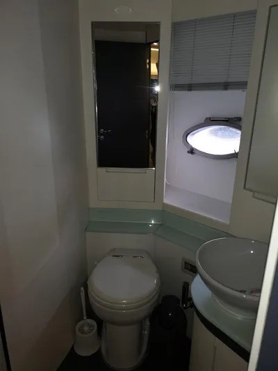  Yacht Photos Pics Bathroom interior of a 2007 Pershing 62 yacht with modern fixtures and porthole window.