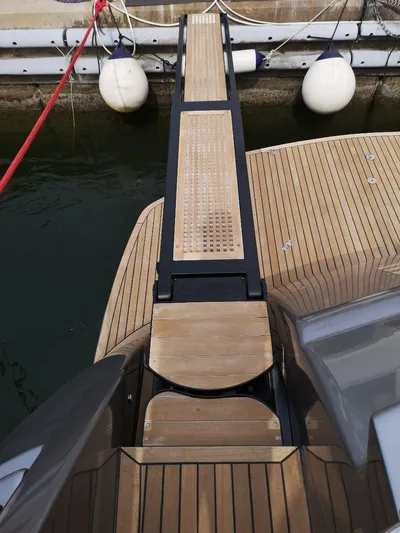  Yacht Photos Pics Boarding platform of a 2007 Pershing 62 yacht docked at a marina.