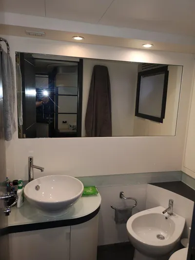  Yacht Photos Pics Luxury bathroom in 2007 Pershing 62 yacht with modern sink and mirror.