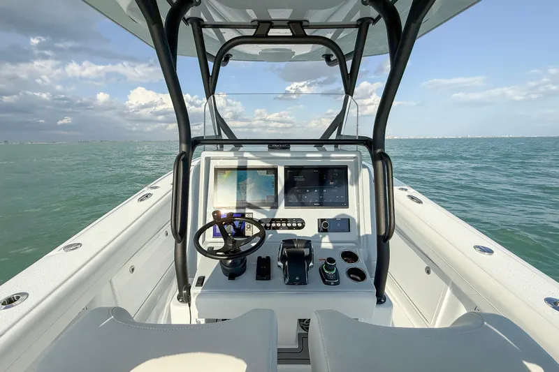  Yacht Photos Pics 2026 Yellowfin 34 Offshore boat dashboard with ocean view, featuring modern navigation equipment.