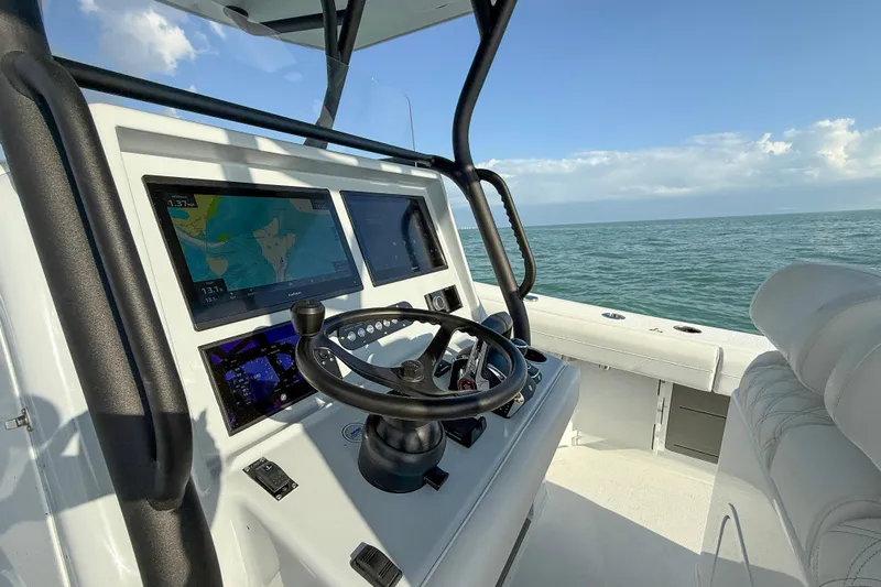  Yacht Photos Pics 2026 Yellowfin 34 Offshore boat cockpit with navigation screens and steering wheel.