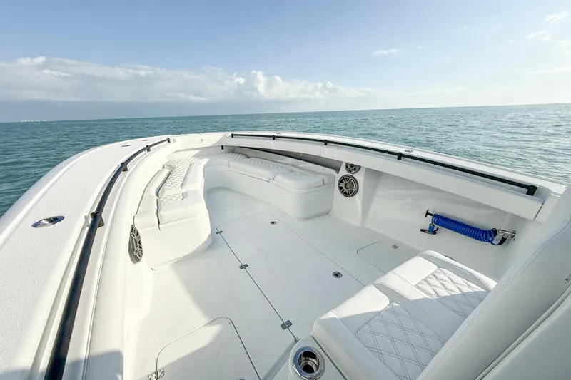  Yacht Photos Pics 2026 Yellowfin 34 Offshore boat interior with white seating, ocean view, and clear sky.