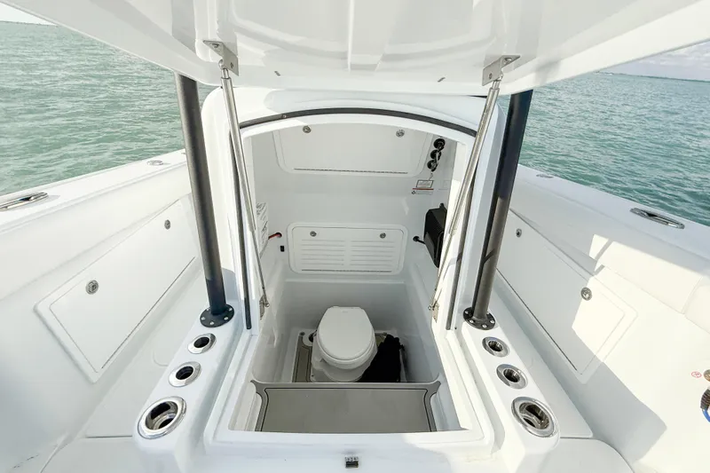  Yacht Photos Pics 2026 Yellowfin 34 Offshore boat interior with open hatch and marine toilet.