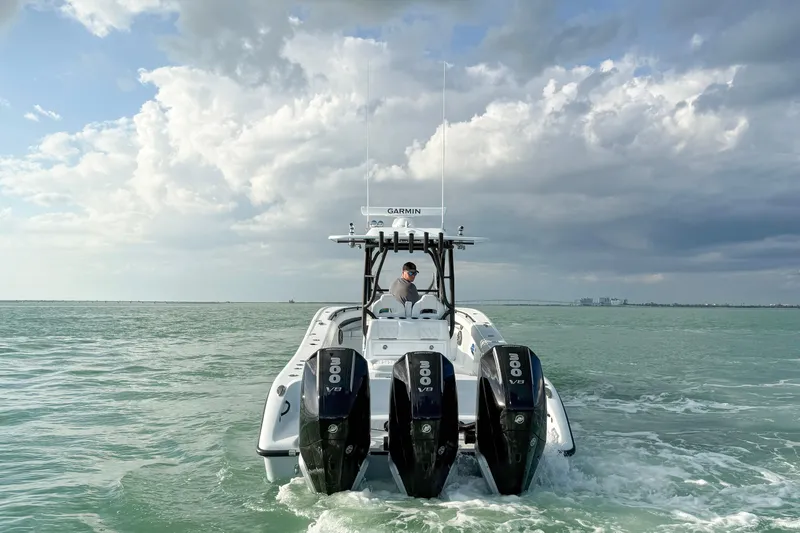  Yacht Photos Pics 2026 Yellowfin 34 Offshore boat with triple 300 V8 engines on open water.