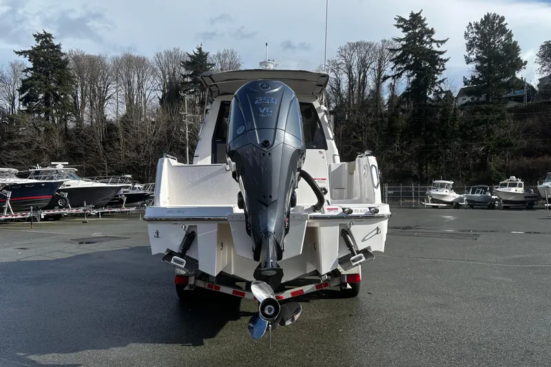  Yacht Photos Pics 2026 Cutwater C-248 Coupe boat with powerful outboard motor, parked in marina.