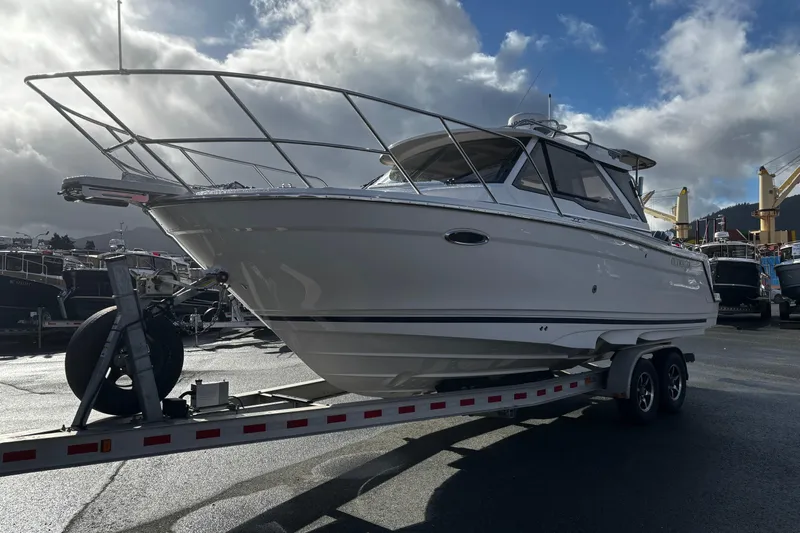  Yacht Photos Pics 2026 Cutwater C-248 Coupe boat on trailer under cloudy sky at marina.