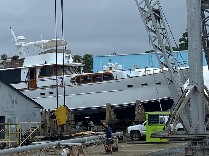  Yacht Photos Pics Pluckebaum Custom 2000 yacht in dry dock, surrounded by industrial equipment.