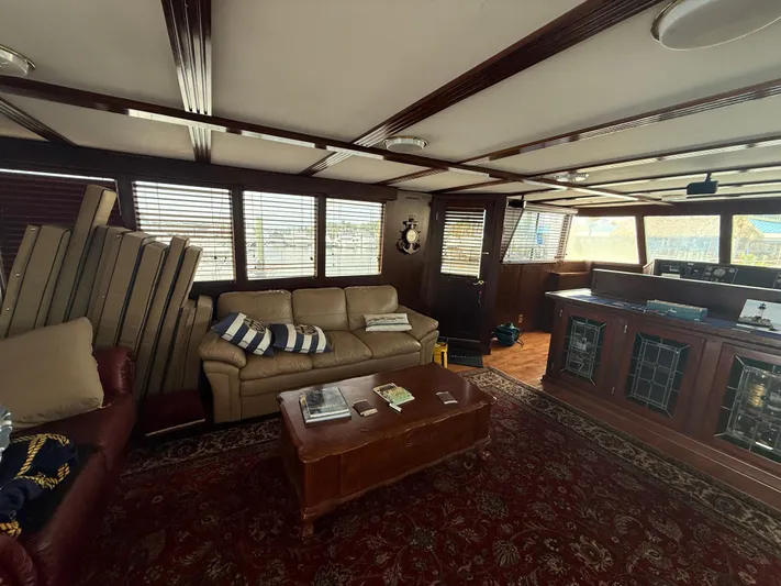  Yacht Photos Pics Luxurious interior of a 2000 Pluckebaum Custom yacht with leather seating and wooden accents.