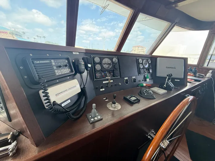  Yacht Photos Pics Control panel of a 2000 Pluckebaum Custom boat with navigation equipment and steering wheel.