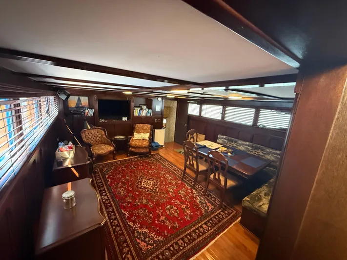  Yacht Photos Pics Luxurious interior of a 2000 Pluckebaum Custom yacht with elegant furnishings and a red patterned rug.