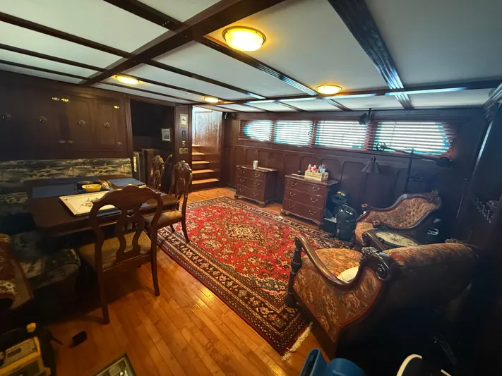  Yacht Photos Pics Luxurious interior of a 2000 Pluckebaum Custom boat with elegant wood paneling and vintage furnishings.