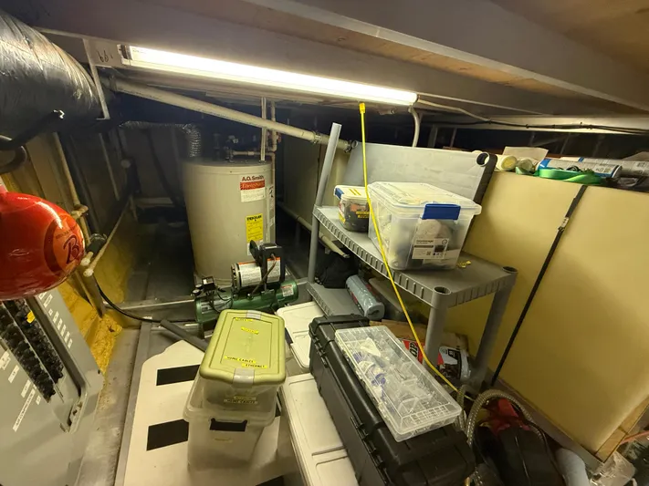  Yacht Photos Pics Engine room of a 2000 Pluckebaum Custom boat with storage and equipment.