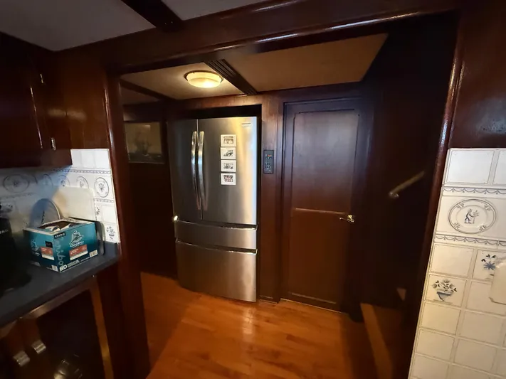  Yacht Photos Pics Wood-paneled kitchen with stainless steel refrigerator, Pluckebaum Custom 2000 model.