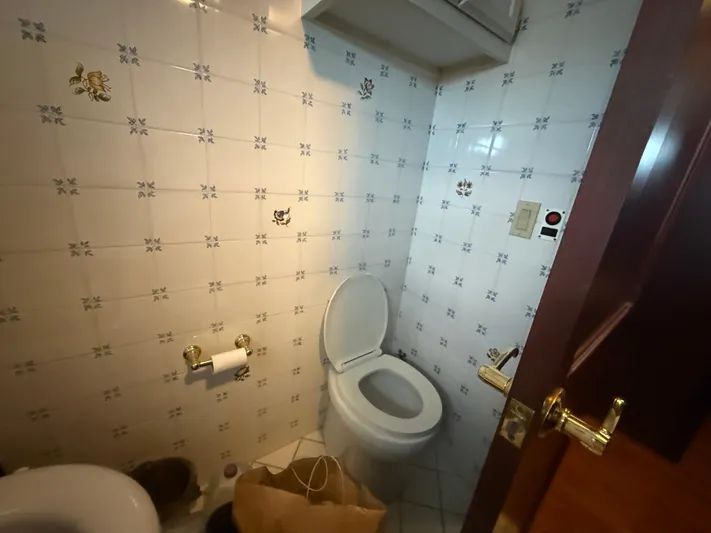  Yacht Photos Pics Small bathroom with tiled walls, toilet, and paper holder in a Pluckebaum Custom 2000 model.