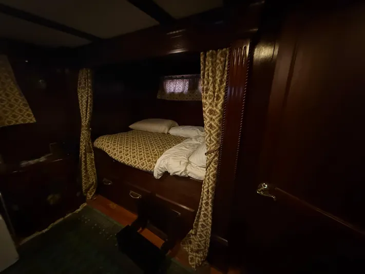  Yacht Photos Pics Cozy cabin interior with patterned bedding on a Pluckebaum Custom boat, year 2000.