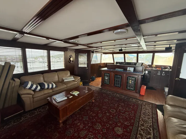  Yacht Photos Pics Luxurious interior of a 2000 Pluckebaum Custom yacht with leather seating and wooden accents.