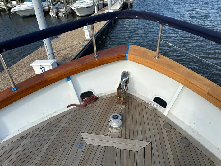  Yacht Photos Pics Bow of 2000 Pluckebaum Custom boat with wooden deck and railing, docked at marina.