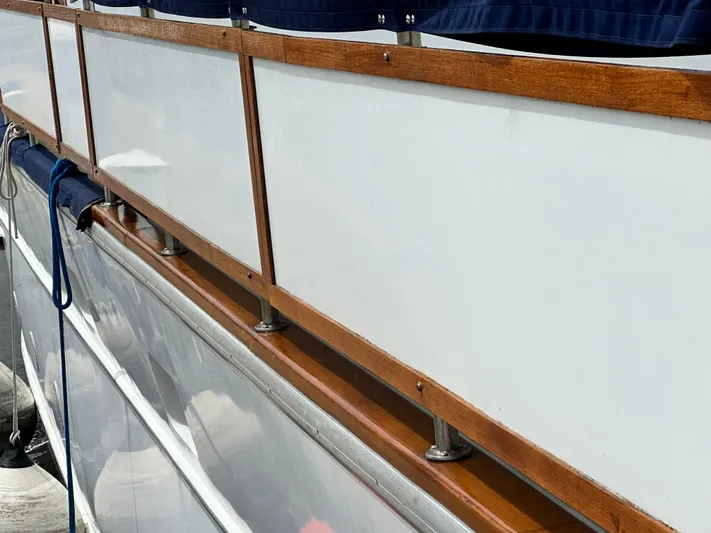  Yacht Photos Pics Pluckebaum Custom 2000 boat with wooden railing and white paneling detail.