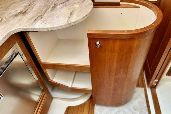 Linda Lou Yacht Photos Pics Interior of a 2018 Legacy 36 yacht with wooden cabinets and marble countertop.