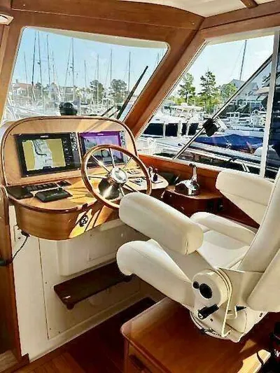 Linda Lou Yacht Photos Pics Interior of a 2018 Legacy 36 boat with steering wheel and navigation system.