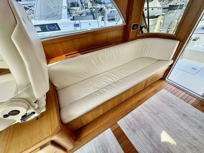 Linda Lou Yacht Photos Pics Interior of a 2018 Legacy 36 yacht with white sofa and wooden flooring.