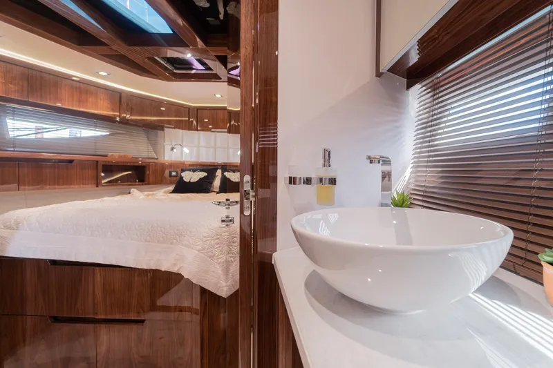 Lady C Yacht Photos Pics Luxurious interior of 2022 Galeon 485 HTS yacht with elegant bedroom and modern bathroom.