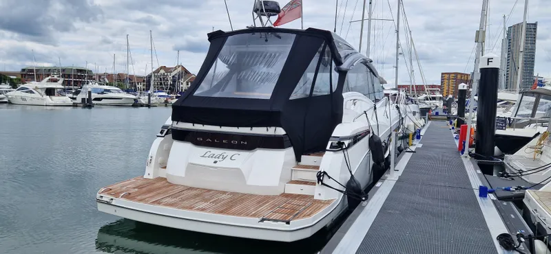 Lady C Yacht Photos Pics 2022 Galeon 485 HTS yacht docked at marina, featuring sleek design and covered deck.
