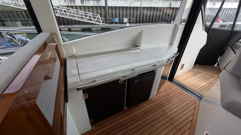 Lady C Yacht Photos Pics Interior view of 2022 Galeon 485 HTS yacht with sleek wooden flooring and modern cabinetry.