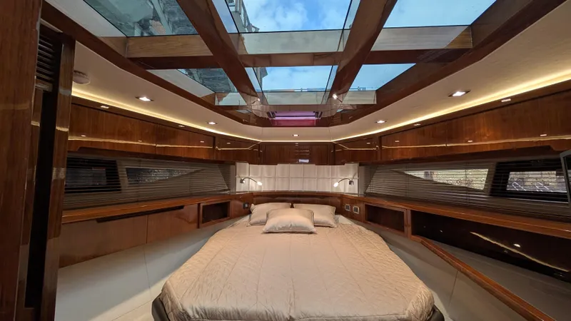 Lady C Yacht Photos Pics Luxurious interior of 2022 Galeon 485 HTS yacht with skylight and elegant wood finishes.