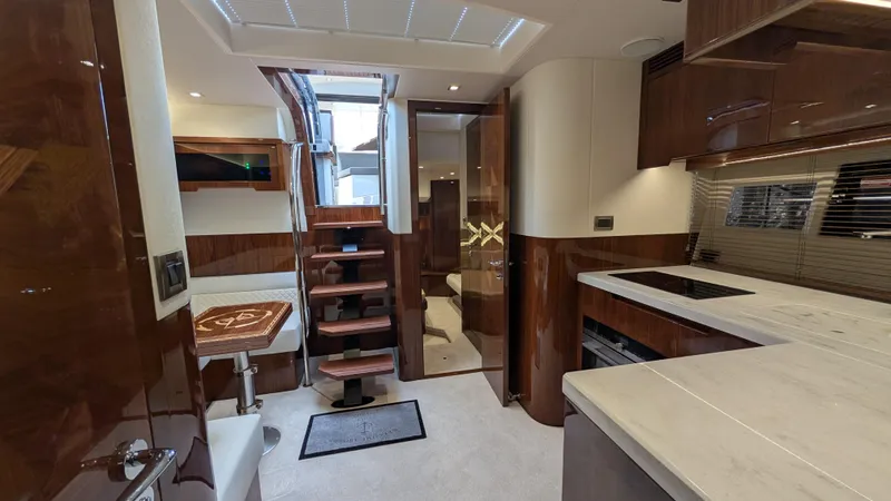 Lady C Yacht Photos Pics Luxurious interior of 2022 Galeon 485 HTS yacht with modern kitchen and wooden accents.