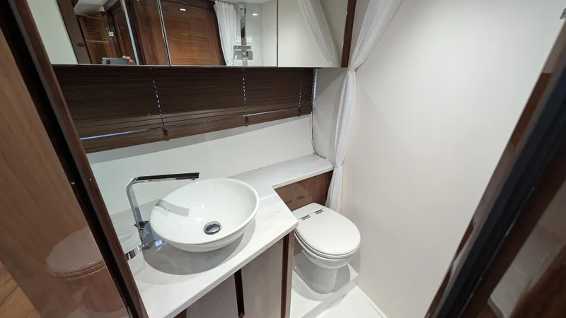 Lady C Yacht Photos Pics Modern bathroom in 2022 Galeon 485 HTS yacht with sleek sink and toilet.
