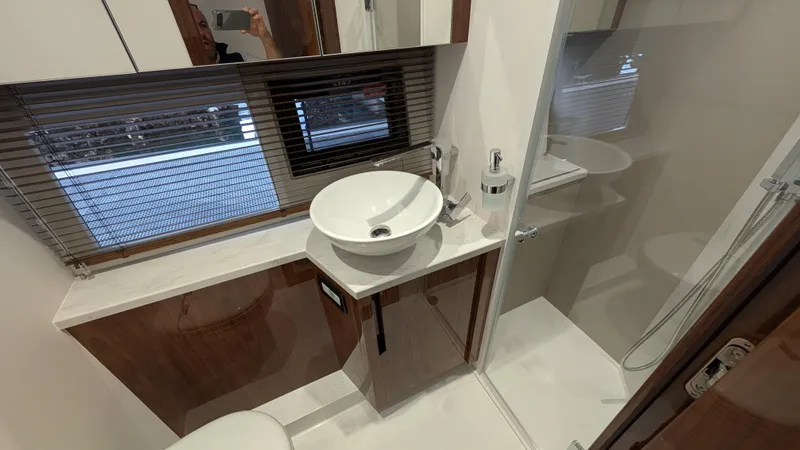Lady C Yacht Photos Pics Modern bathroom in 2022 Galeon 485 HTS yacht with sleek fixtures and wooden cabinetry.