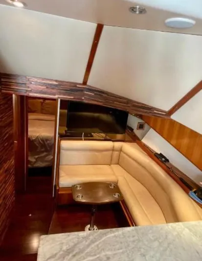  Yacht Photos Pics Interior of 1994 Viking 38 Convertible yacht with cozy seating and wooden accents.
