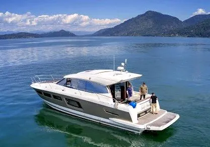 Easily Amused Yacht Photos Pics 2017 Prestige 500 S yacht cruising on a serene lake with mountainous backdrop.