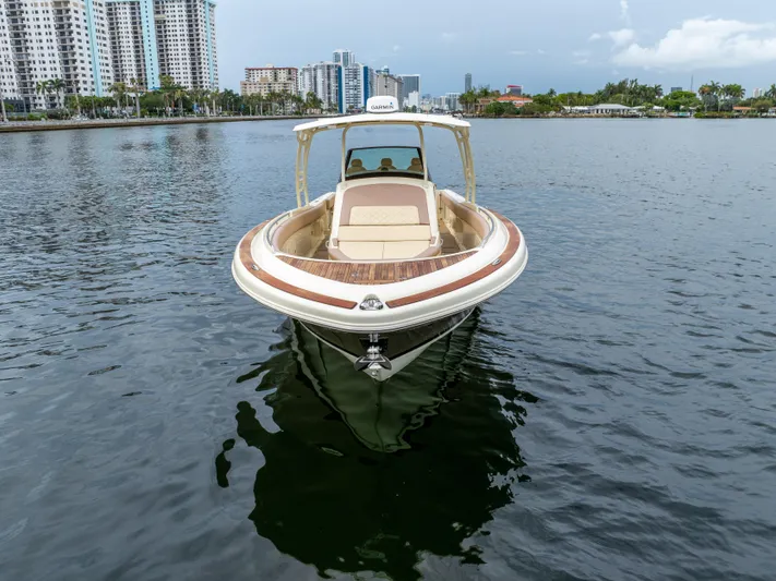 Lady Liberty Yacht Photos Pics 2018 Chris-Craft Catalina 34 boat on calm water with city skyline background.