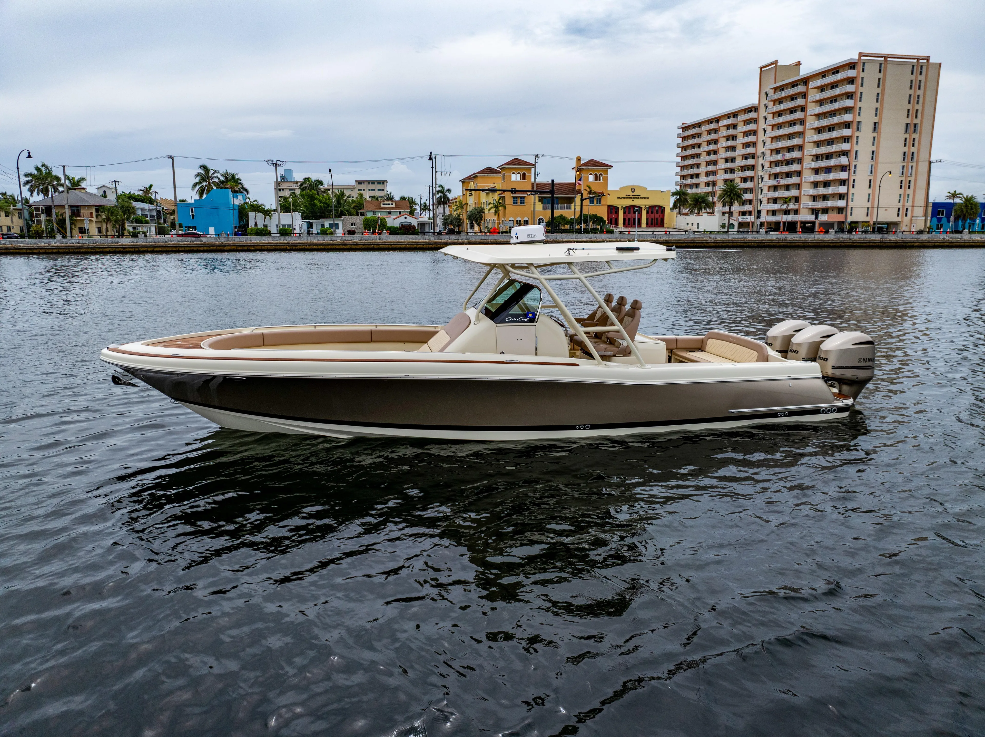 Lady Liberty Yacht Photos Pics 2018 Chris-Craft Catalina 34 boat on water, cityscape background.
