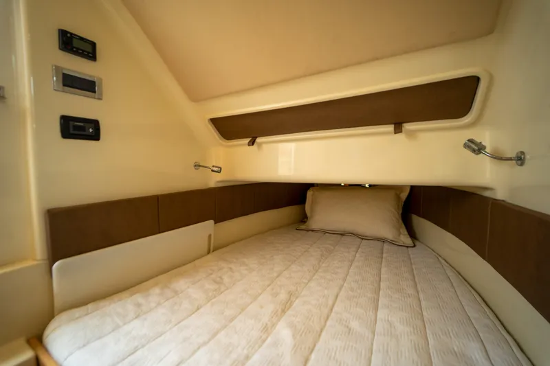 Lady Liberty Yacht Photos Pics 2018 Chris-Craft Catalina 34 cabin interior with cozy bed and modern controls.