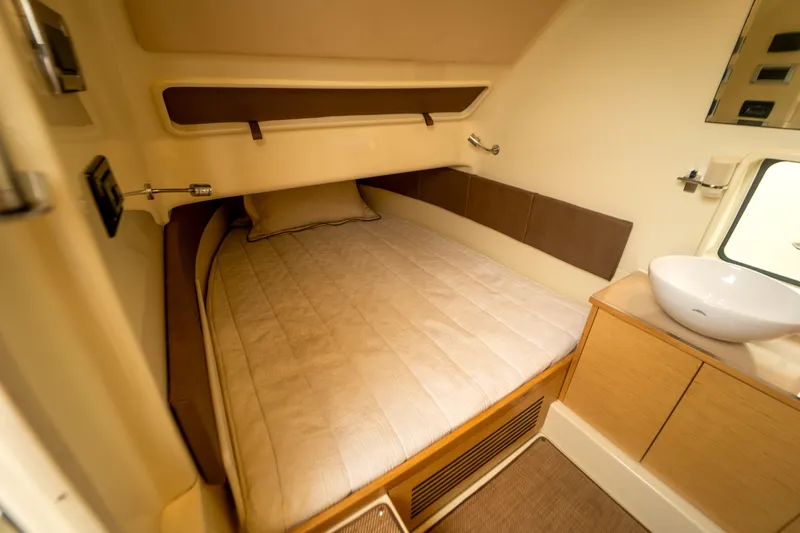 Lady Liberty Yacht Photos Pics 2018 Chris-Craft Catalina 34 cabin interior with bed and sink, showcasing luxury design.