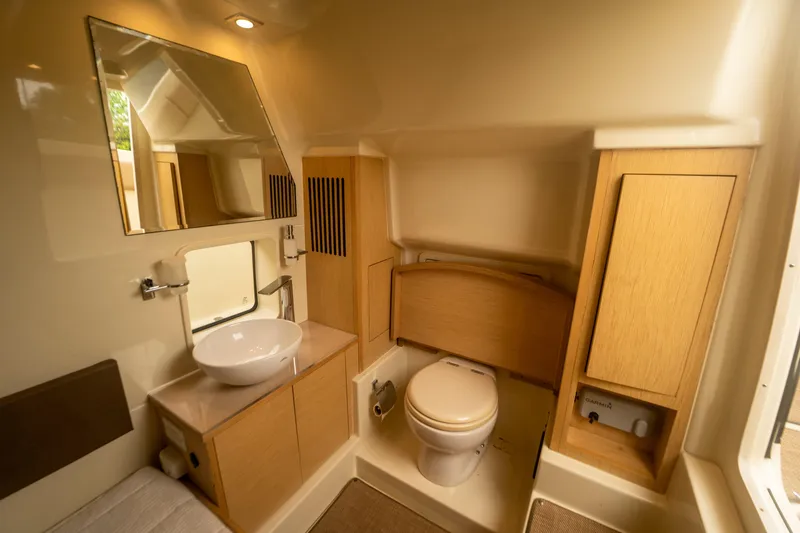 Lady Liberty Yacht Photos Pics 2018 Chris-Craft Catalina 34 bathroom with modern fixtures and wooden cabinetry.