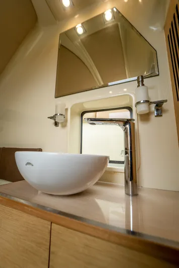 Lady Liberty Yacht Photos Pics Luxurious bathroom interior of 2018 Chris-Craft Catalina 34 with modern sink and fixtures.