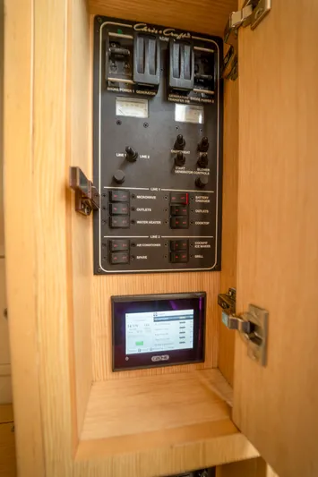 Lady Liberty Yacht Photos Pics Electrical control panel inside 2018 Chris-Craft Catalina 34 boat, featuring switches and digital display.