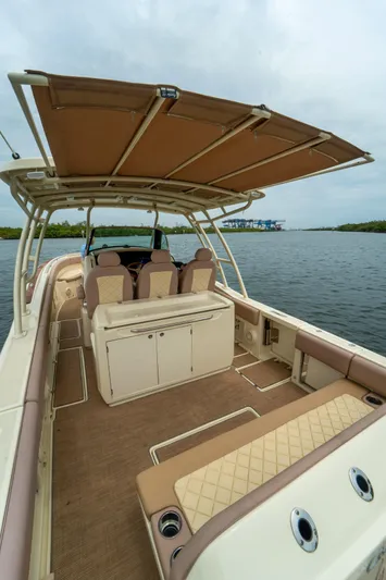 Lady Liberty Yacht Photos Pics 2018 Chris-Craft Catalina 34 boat interior with seating and canopy on calm water.
