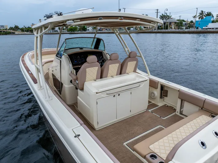 Lady Liberty Yacht Photos Pics 2018 Chris-Craft Catalina 34 boat interior with seating and helm, docked on calm water.