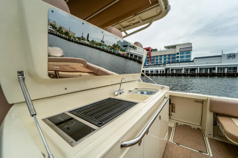 Lady Liberty Yacht Photos Pics 2018 Chris-Craft Catalina 34 boat with outdoor kitchen, sink, and grill by waterfront.