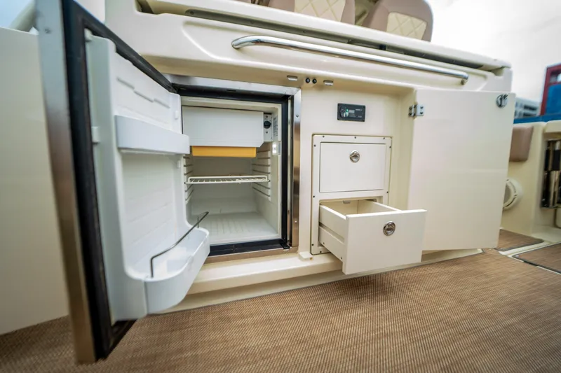 Lady Liberty Yacht Photos Pics 2018 Chris-Craft Catalina 34 interior with open fridge and storage drawers.
