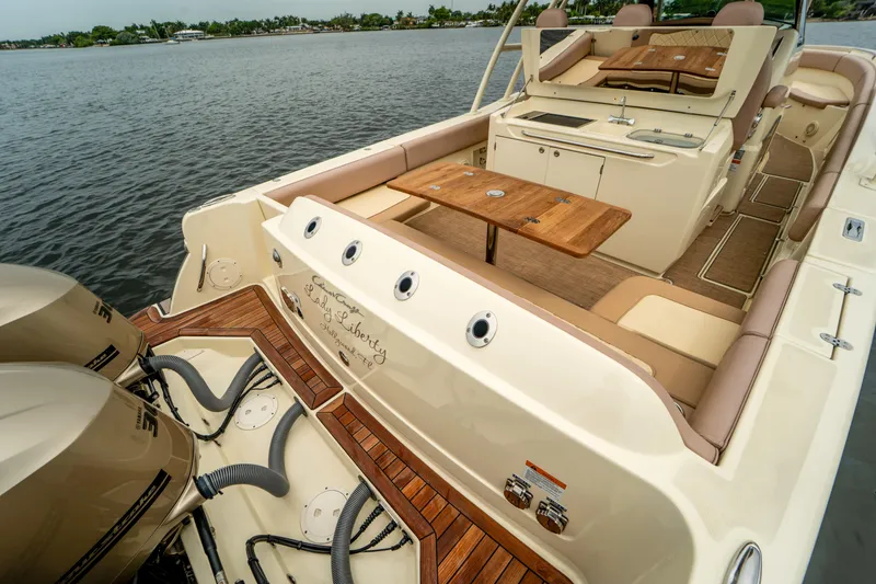 Lady Liberty Yacht Photos Pics 2018 Chris-Craft Catalina 34 boat with spacious deck and seating, docked on calm water.