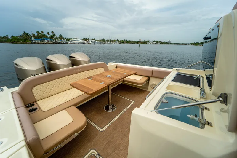 Lady Liberty Yacht Photos Pics 2018 Chris-Craft Catalina 34 boat interior with seating, table, and water view.